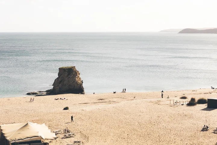 Sea stack and sandy beach — photograph by Monty Bray