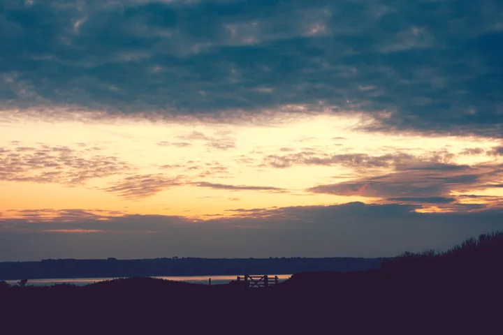Golden sky over the coast — photograph by Monty Bray