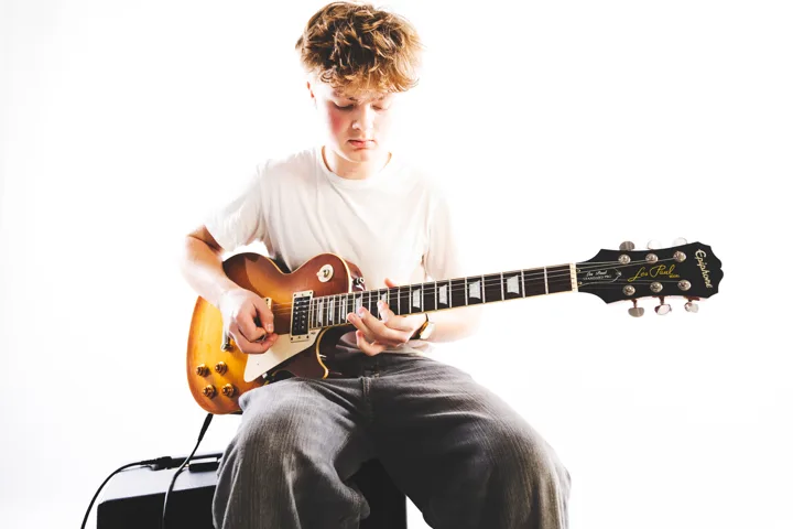 Fair-haired guitarist, studio — photograph by Monty Bray