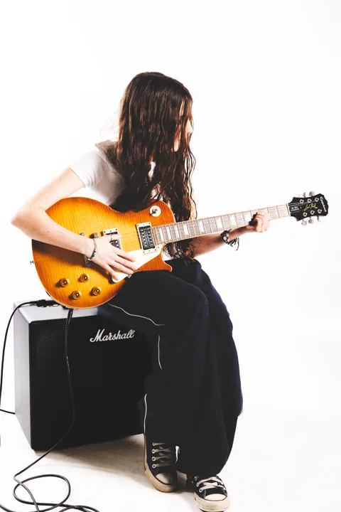 Long-haired guitarist, studio — photograph by Monty Bray