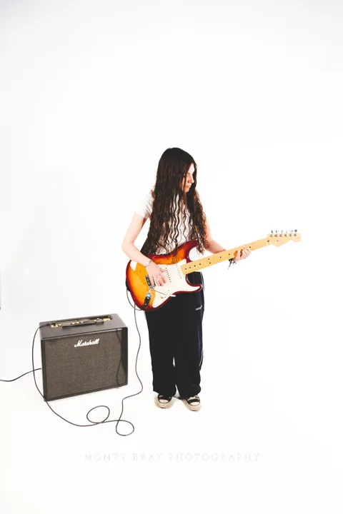 Long-haired guitarist, studio — photograph by Monty Bray