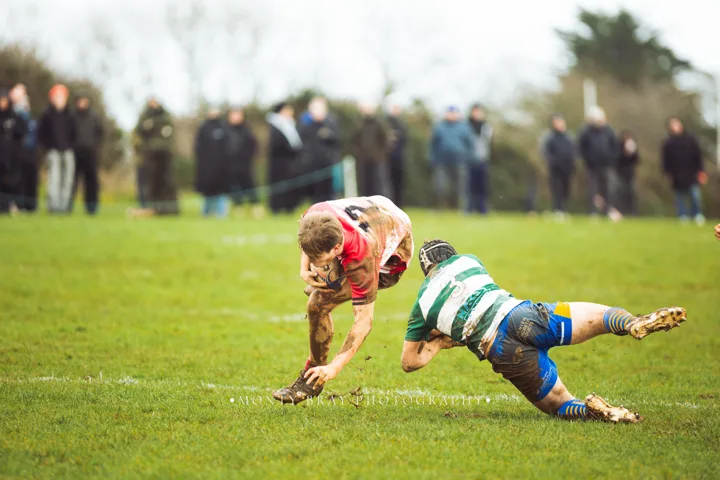 Muddy daylight running and tackles — photograph by Monty Bray
