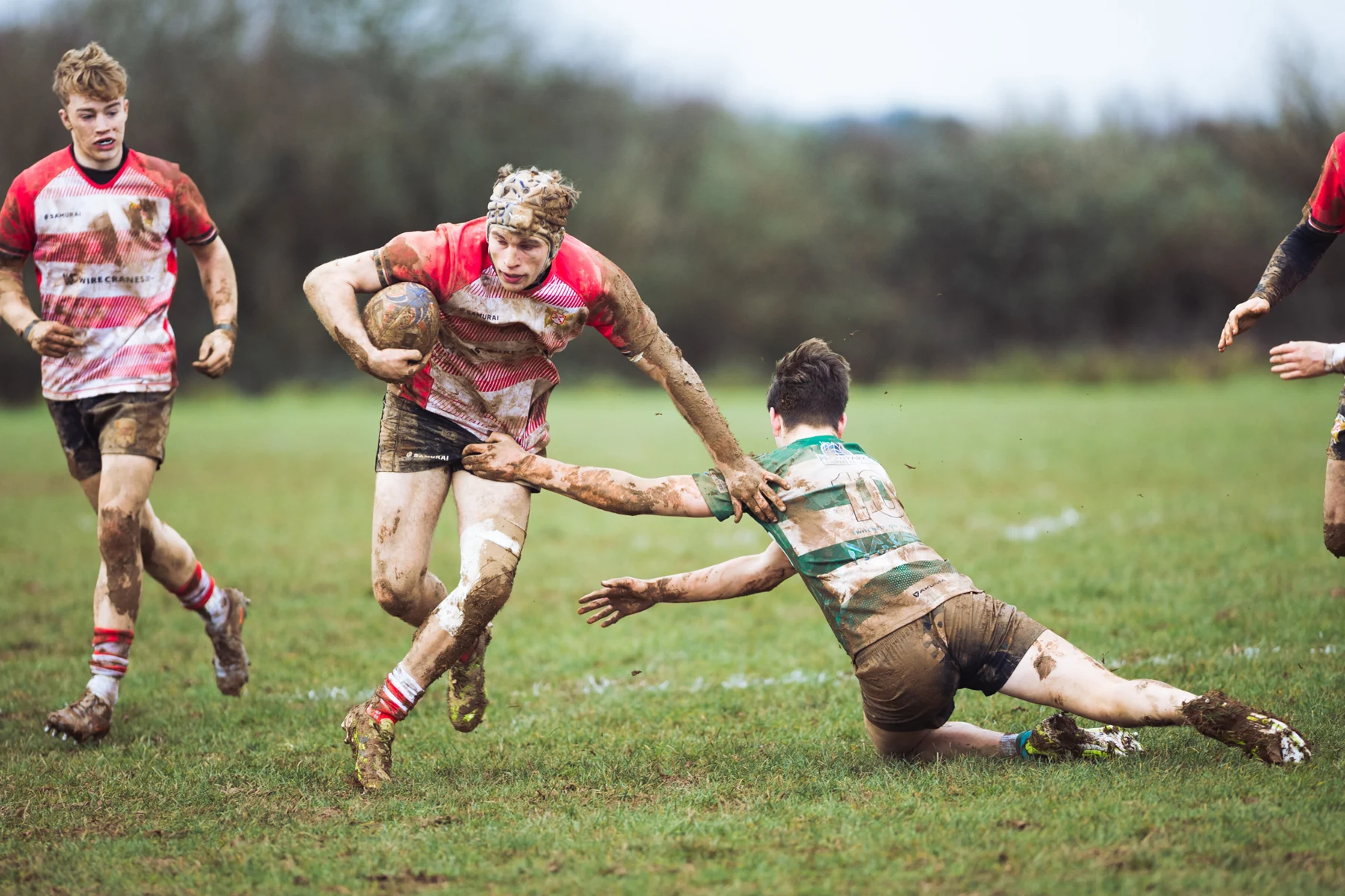 Muddy daylight running and tackles — photograph by Monty Bray