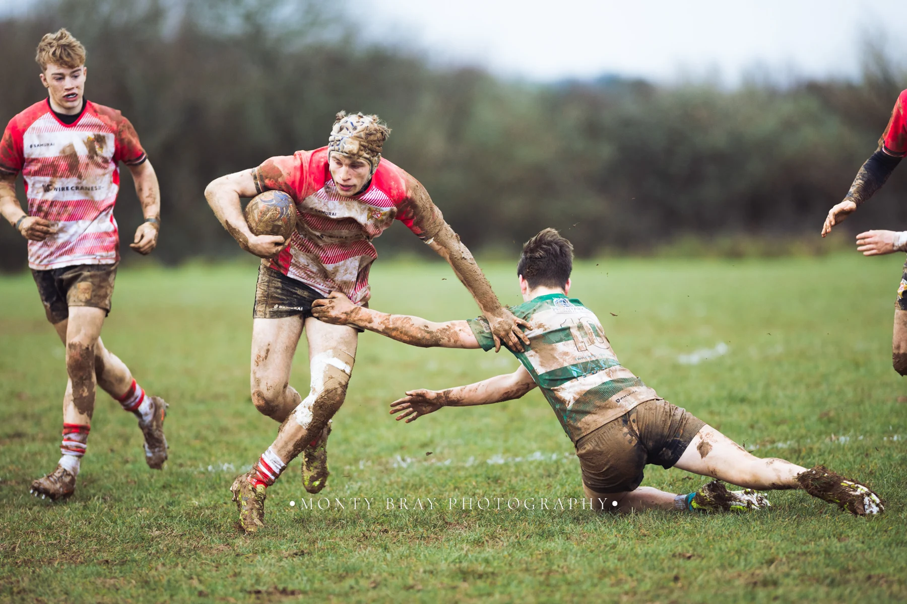 Muddy daylight running and tackles — photograph by Monty Bray